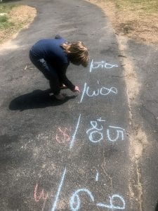 A student from Gloucester County Special Services School District makes the best of at-home learning by practicing math outdoors.