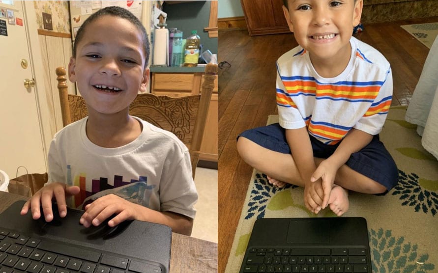 SCSSSD young learners, Chance DelGrippo and his brother Naideem DelGrippo smile while seated in front of their laptops, which they used to work on assignments.