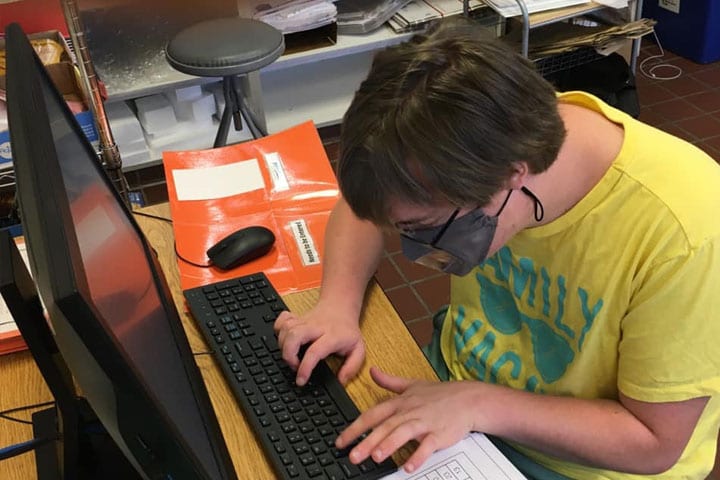 A BurlCo Special Services student practices job skills on a computer in the district's Work-Based Learning Lab.