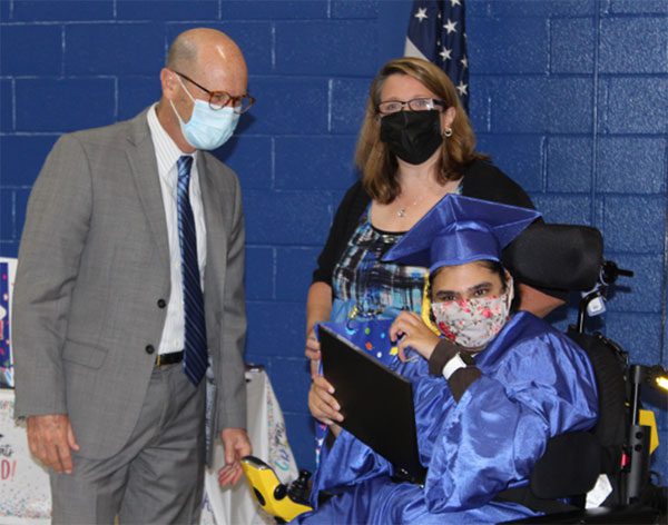 Dr. Howard Lerner, Superintendent of Bergen County Special Services School District is seen with a student, who had just received their diploma.