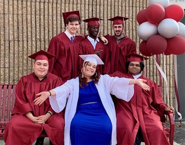 Graduates of BCSSSD’s NOVA program gather together and smile for the camera following the commencement ceremony.