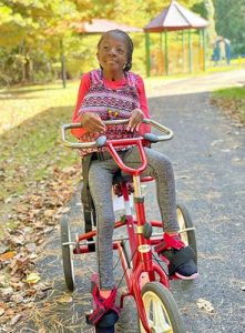 BCSSSD student riding a tricycle