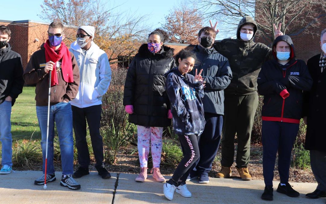 Burlington County Special Serices School District students pose outside wearing masks and winter coats along with superintendent Dr. Chris Nagy.