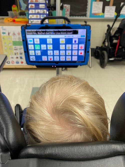 A student is looking at a screen that uses his eye gaze to communicate with the help of a specialized speech device.