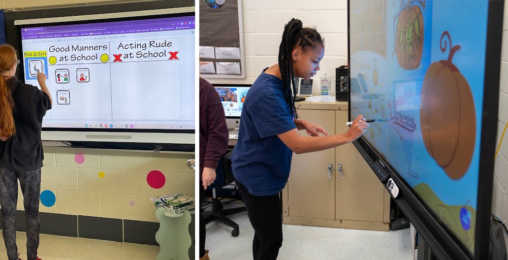 A student is facing a large interactive touch screen and using their finger to move items on the screen. A student is using a stylus to do a pumpkin activity on a large interactive touch screen.